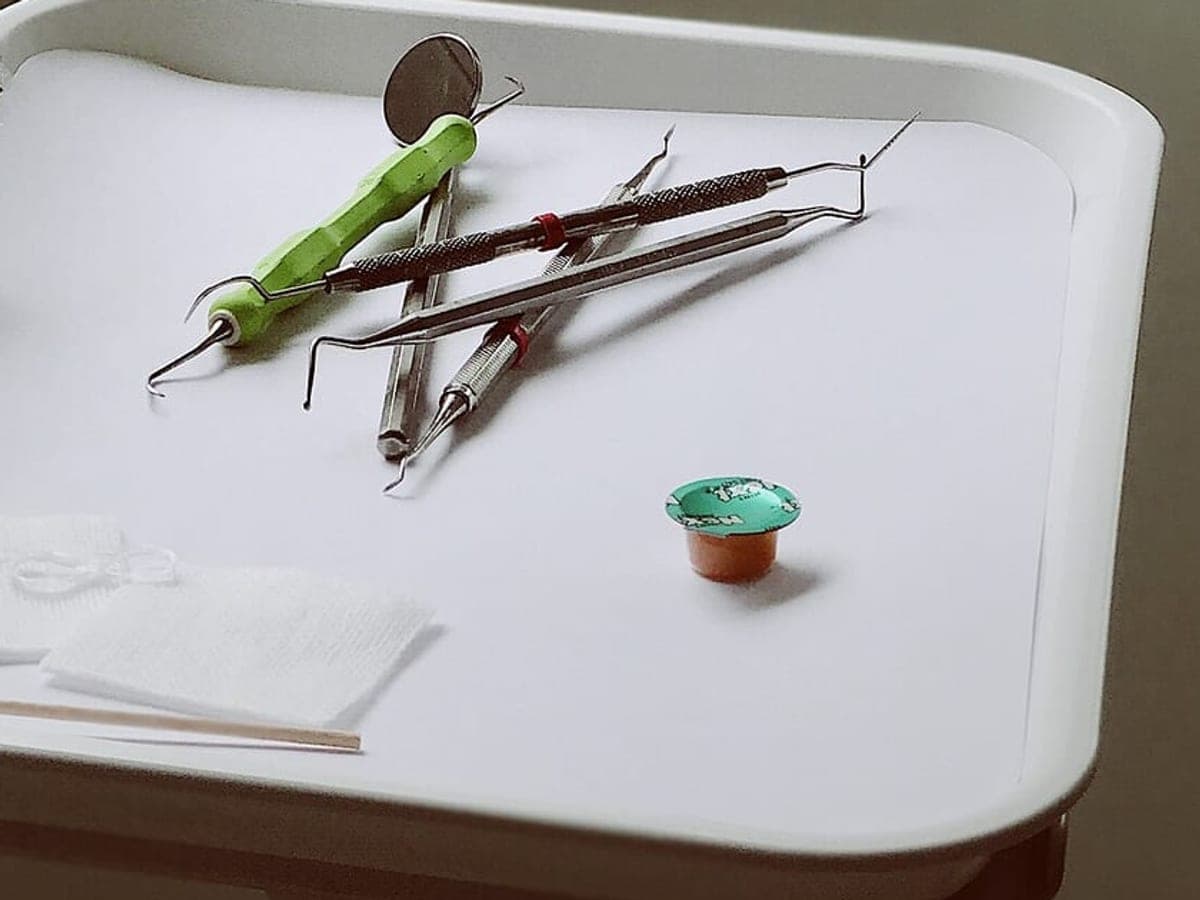 Dental mirror and probes on a white tray